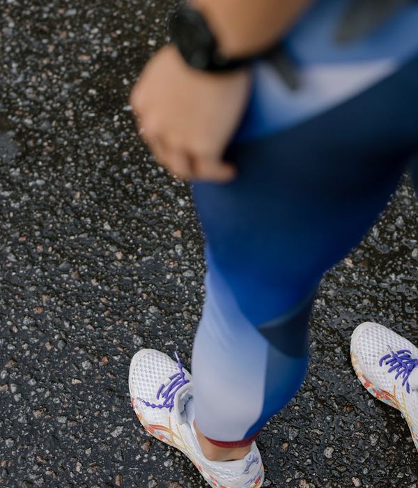 Woman in a steady cardio rhythm wearing modern athletic apparel.